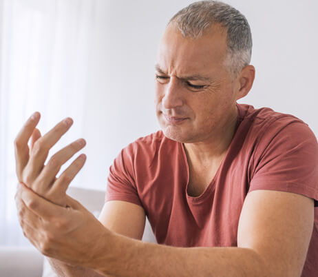 Man whose wrist is in pain due to carpal tunnel syndrome and is in need of a good carpal tunnel doctor.