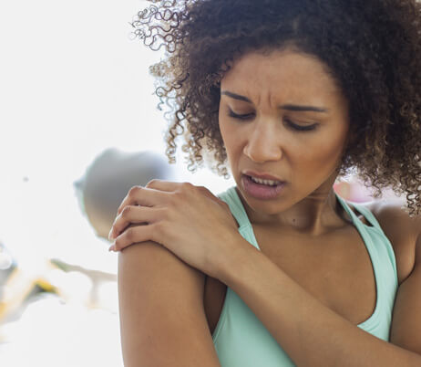 Woman suffering from shoulder pain and in need of treatment.