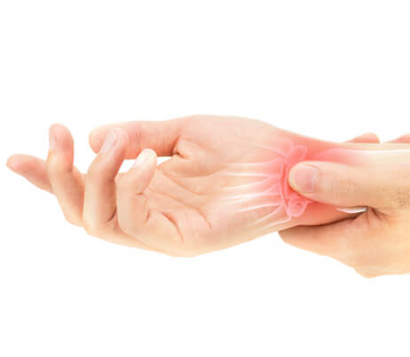 Patient experiencing wrist pain who can benefit from seeing hand doctors.