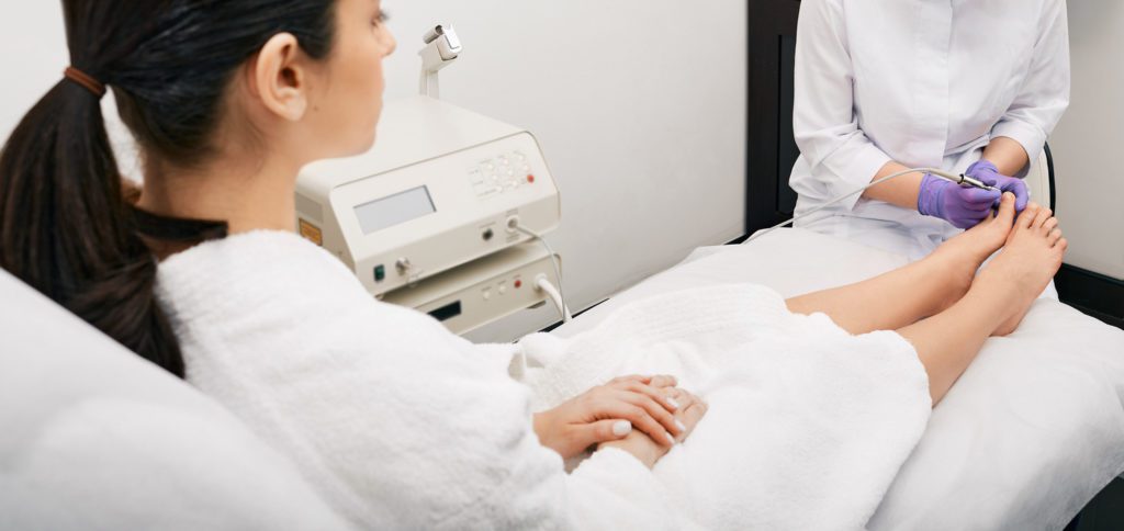 Doctor examining a woman's feet