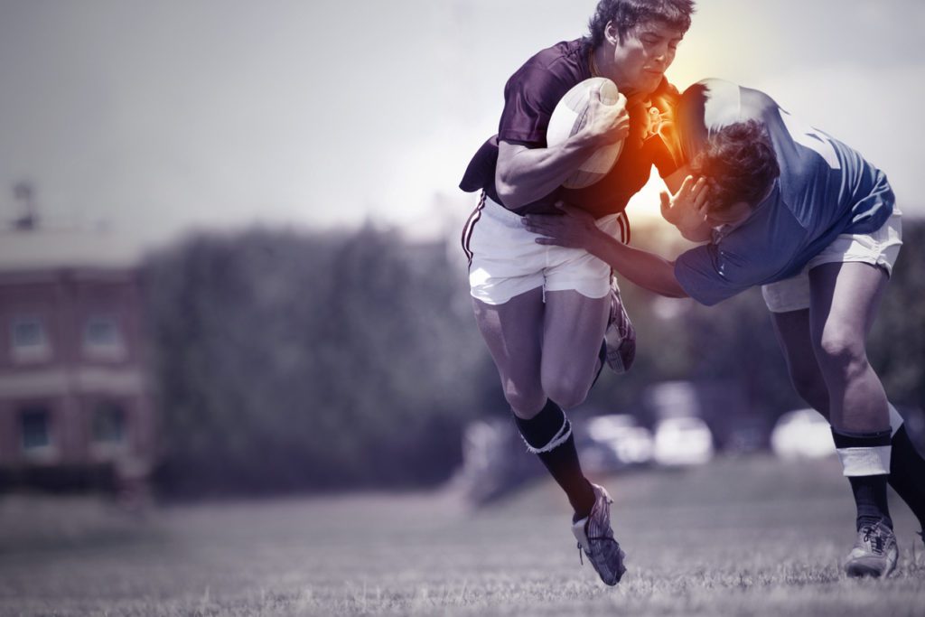 Two rugby players colliding during a game