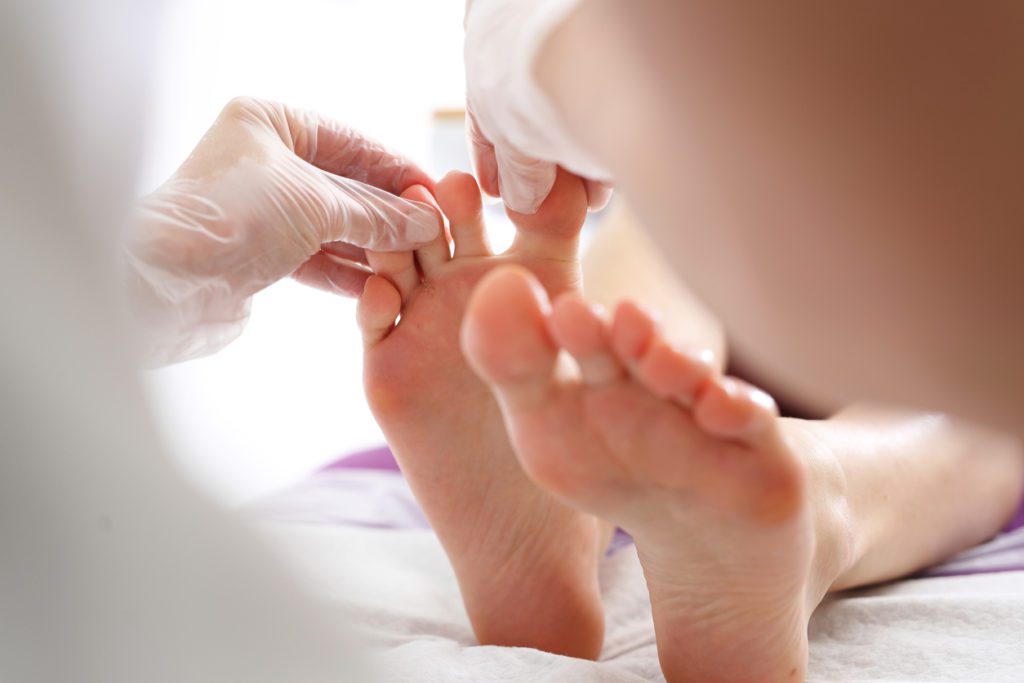 A podiatrist examining a patient's foot