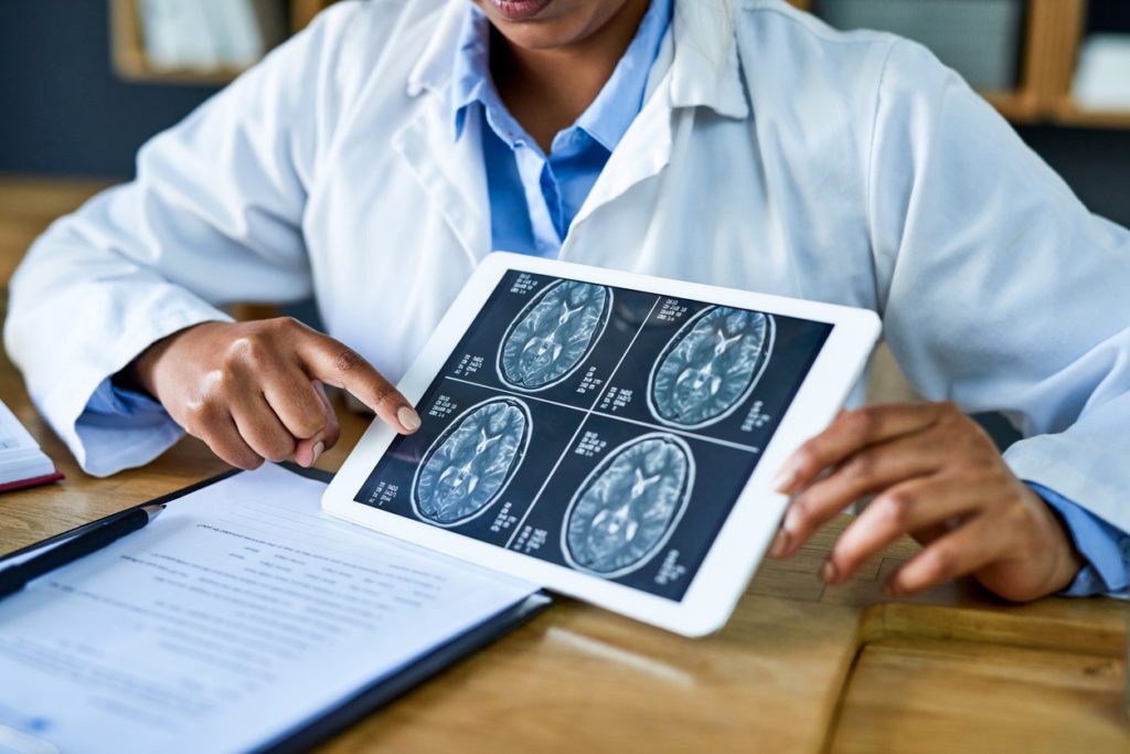 An orthopedic surgeon reviewing an MRI scan of a patient's brain.