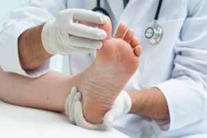 Podiatrist examining a patient's foot