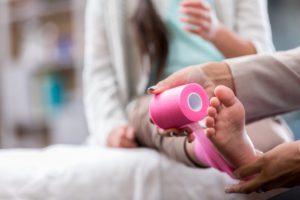 Doctor wrapping a patient's foot
