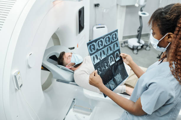 female doctor looking at MRI results on a patient on the MRI