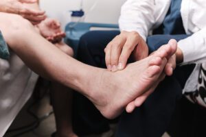Podiatrist Examines Patients Foot