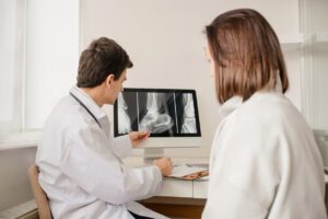 orthopedic surgeon explain x-ray result to the woman patient