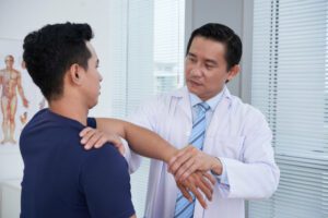 Sports Medicine Physician Examining Sportsman