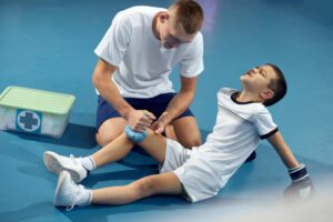 Sport Medicine Doctor giving treatment for athlete injury
