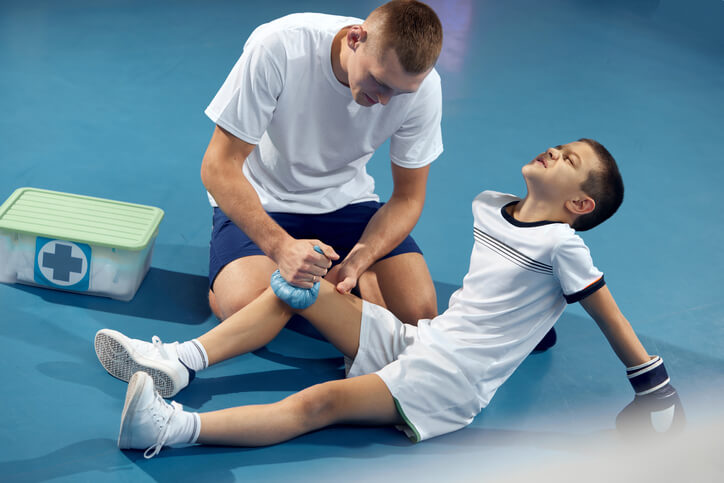 Sport Medicine Doctor giving treatment for athlete injury