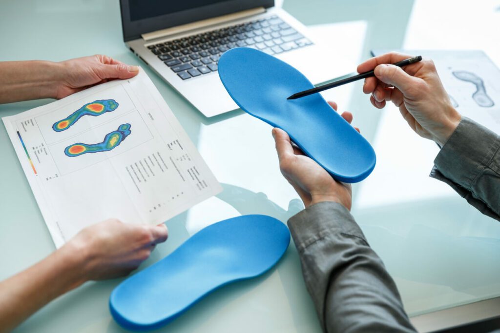 consulting patient on custom orthotic insoles in a clinic for a personalised custom fit