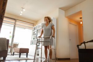 Elderly woman with a walker recovering from hip surgery