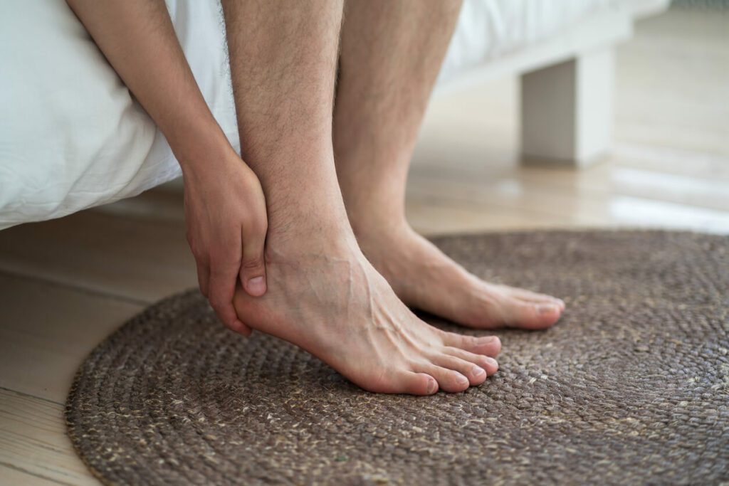 Man experiencing foot pain in need of seeing a plantar fasciitis doctor near him.