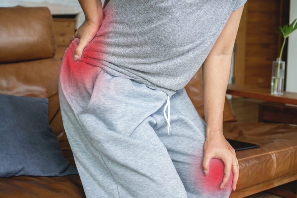 A woman suffering from a knee injury and lower back and buttock pain due to arthritis.