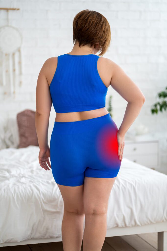 Hip pain, woman suffering from Hip bursitis at home.