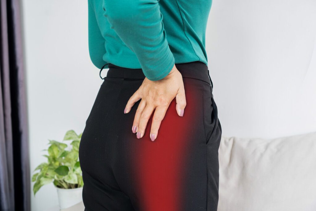 A woman is experiencing hip pain caused by hip bursitis.