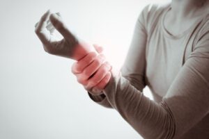 Focus on a Woman suffering from carpal tunnel disorder.