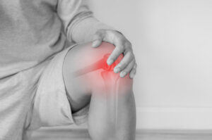 Joint pain, Arthritis and tendon problems. a man touching knee at pain point.
